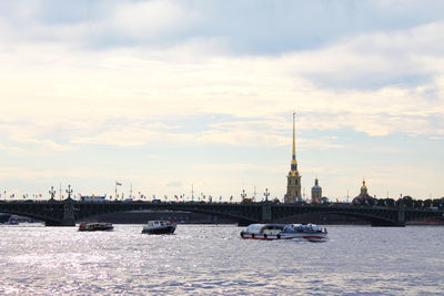 View of bridge over river against cloudy sky