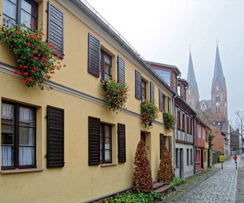 Low angle view of buildings in town against sky