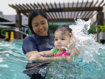 Portrait of mother and daughter in swimming pool
