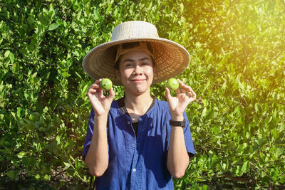 Portrait of smiling man standing against plants