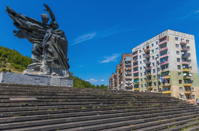 Low angle view of statue against blue sky