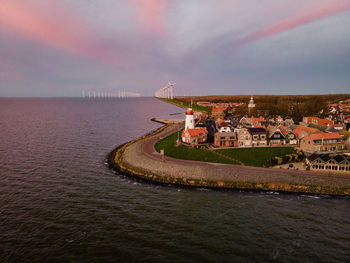 Scenic view of sea and buildings against sky