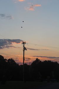 Low angle view of electricity pylon against sky