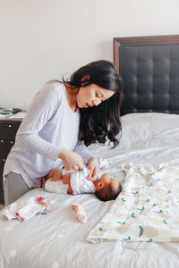 Mother and baby on bed