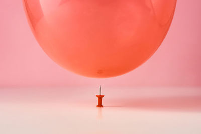 Close-up of balloons against orange sky