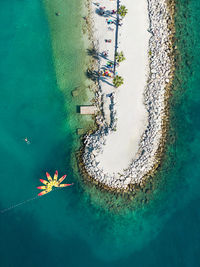 Looking down on a beach near split in croatia with kayak pattern and swimmer