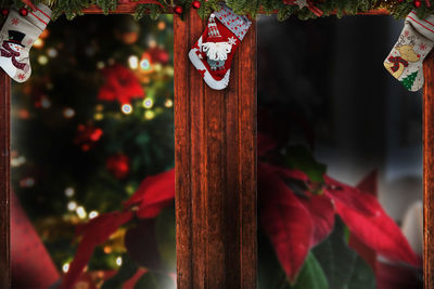 Close-up of cross hanging on wood