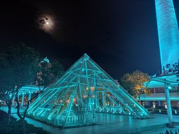 Illuminated building against sky at night