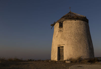 Castle on landscape against clear sky