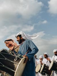 People standing against sky