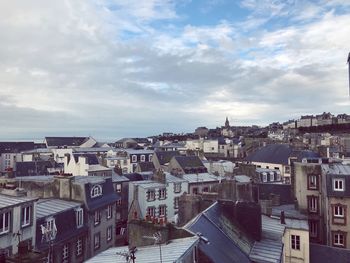 Houses in town against sky