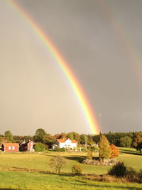 Rainbow over landscape against sky