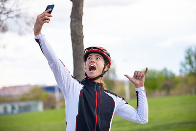 Male athlete taking selfie while standing park