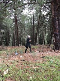 Full length of woman hiking in forest
