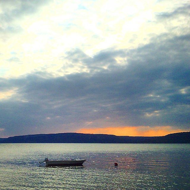 water, sky, sunset, tranquil scene, tranquility, scenics, nautical vessel, cloud - sky, beauty in nature, boat, transportation, lake, nature, mode of transport, sea, cloud, idyllic, cloudy, mountain, reflection