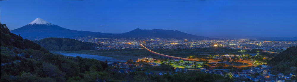 High angle view of city lit up at night