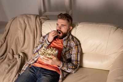 Young man relaxing on bed at home