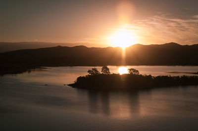 Scenic view of lake against sky during sunset