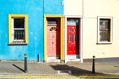 View of brightly colored doors on a blue colored building