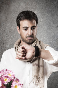 Portrait of man standing against white background