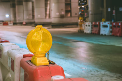Close-up of yellow bell on city street at night