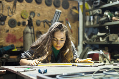 Female mechanic working in garage