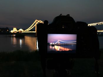 Silhouette of bridge against sky at night