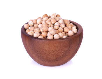 Seeds in bowl against white background