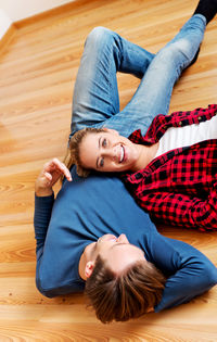 High angle view portrait of baby relaxing on floor at home