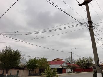 Low angle view of electricity pylon against sky