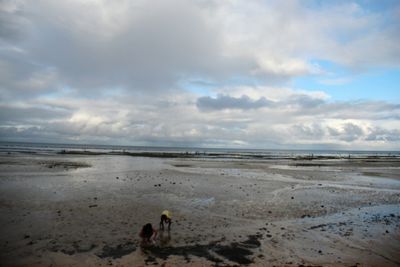 Scenic view of sea against cloudy sky