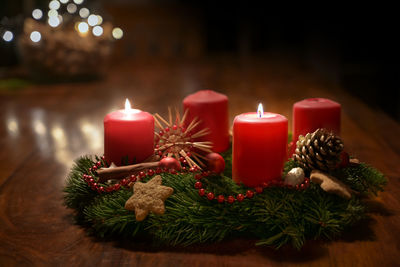 Close-up of illuminated candles on table