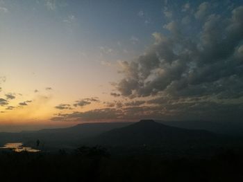 Scenic view of silhouette mountains against sky at sunset