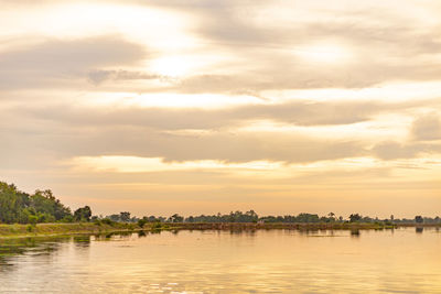 Scenic view of lake against sky at sunset