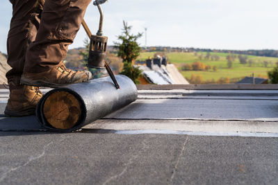 Low section of man standing on road