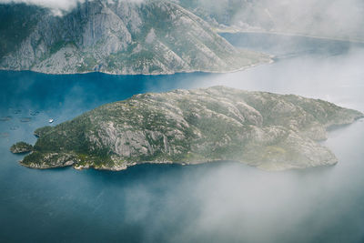 Aerial view of rock in sea against sky