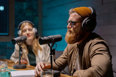 Young people in podcast studio. recording a new radio show.