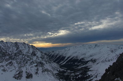 Scenic view of snowcapped mountains against sky during sunset