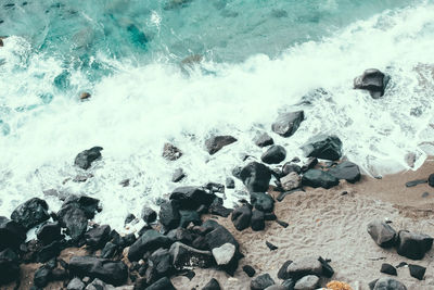 High angle view of rocks in sea