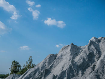 Low angle view of mountain against blue sky