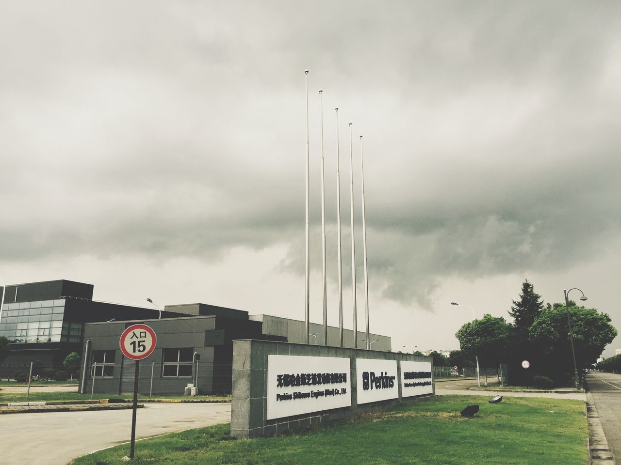 sky, cloud - sky, cloudy, transportation, street light, built structure, architecture, overcast, building exterior, text, communication, road, cloud, western script, day, road sign, outdoors, information sign, weather, mode of transport