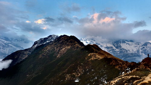 Scenic view of snow covered mountains against sky