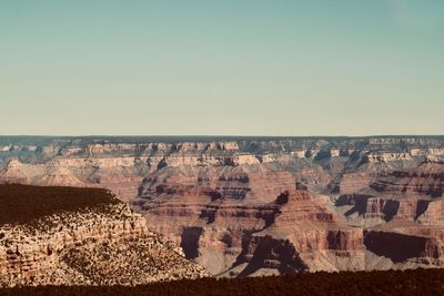 Panoramic view of rock formations against clear sky