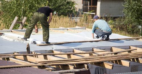 Rear view of worker working at construction site