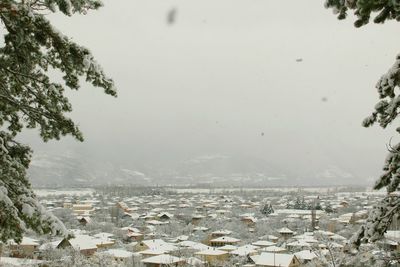 Aerial view of townscape against sky during winter