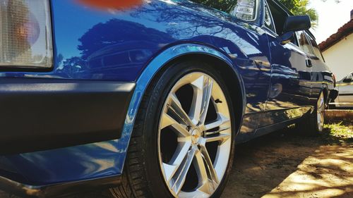 Close-up of car against blue sky