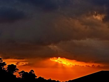 Low angle view of dramatic sky during sunset