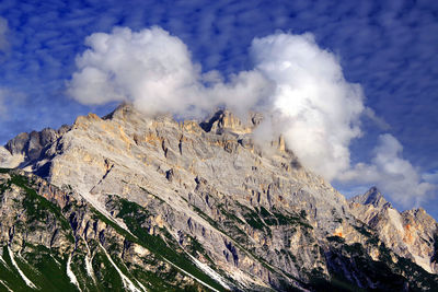 Low angle view of rocky mountains against sky