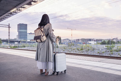 Woman waiting at train station platform