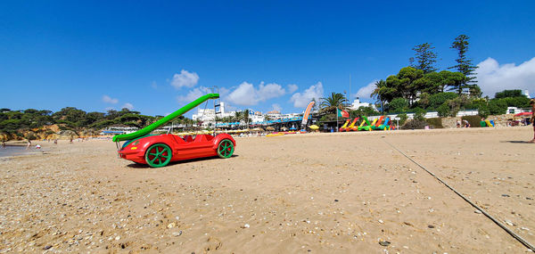 Panoramic view of beach against blue sky on sunny day